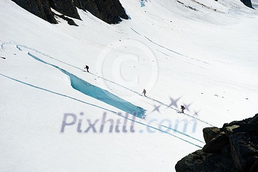 Group of people walking among snows of New Zealand mountains Group of people walking among snows of New Zealand mountains