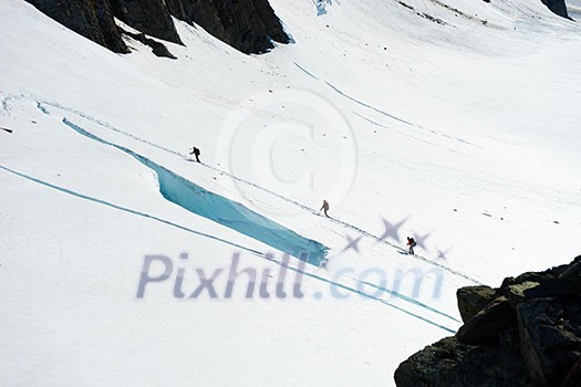 Group of people walking among snows of New Zealand mountains