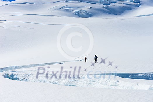 Group of people walking among snows of New Zealand Alps Group of people walking among snows of New Zealand Alps