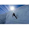 Low angle view of man climbing glacier