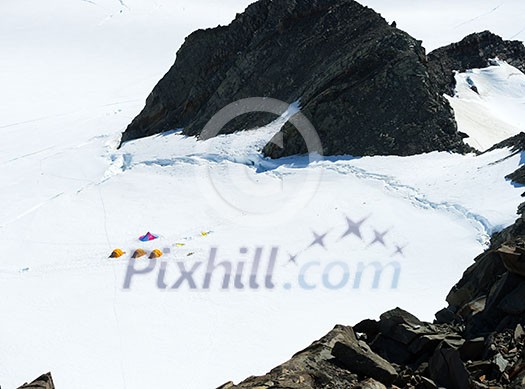 Mountain landscape with three tents among snows Mountain landscape with three tents among snows