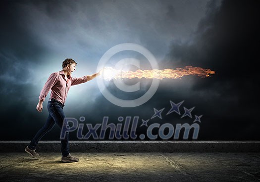 Young man in casual throwing fire ball Young man in casual throwing fire ball