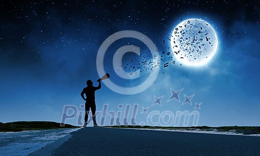 Silhouette of man screaming in trumpet at night
