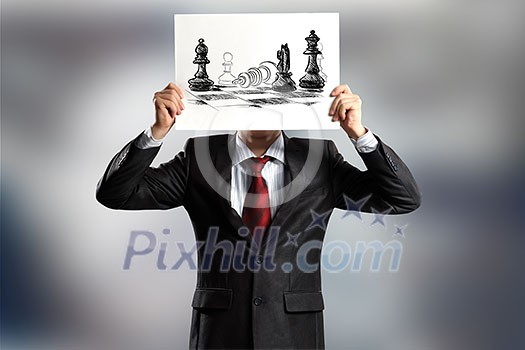 Businessman hiding face behind paper sheet. Strategy concept Businessman hiding face behind paper sheet. Strategy concept