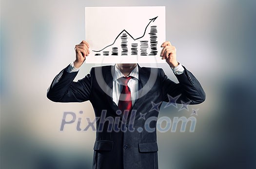 Businessman hiding his face behind paper sheet with sketches Businessman hiding his face behind paper sheet with sketches