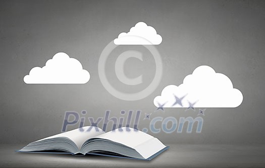Opened book with white clouds above pages Opened book with white clouds above pages