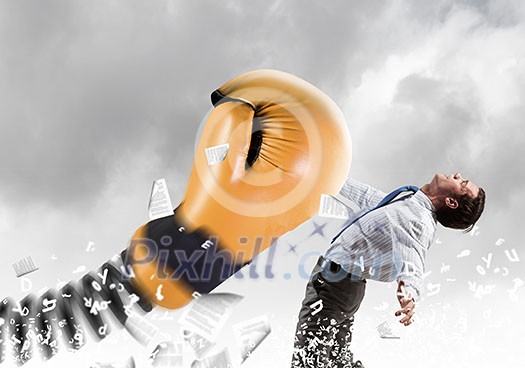 Young determined businessman fighting boxing glove on spring Young determined businessman fighting boxing glove on spring