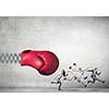 Boxing glove on spring striking group of businesspeople