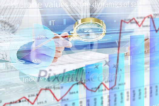 Close up of business person investigating infographs with magnifier Close up of business person investigating infographs with magnifier