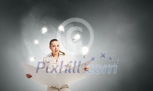 Portrait of young businesswoman in white suit reading blank newspaper Portrait of young businesswoman in white suit reading blank newspaper