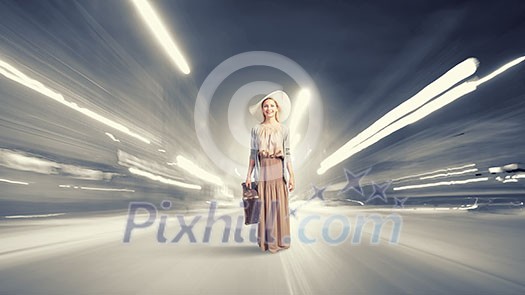 Beautiful woman with retro suitcase walking on road Beautiful woman with retro suitcase walking on road