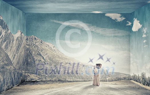 Beautiful woman with retro suitcase walking on hill top Beautiful woman with retro suitcase walking on hill top