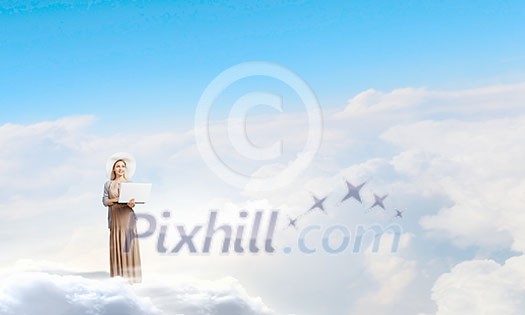 Young lady standing on cloud and using laptop Young lady standing on cloud and using laptop