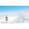 Young lady standing on cloud and using laptop