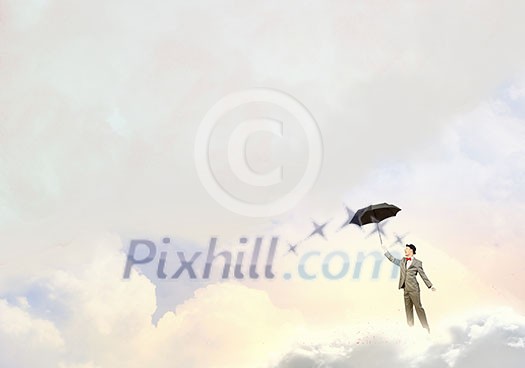 Businessman standing with umbrella under white cloud Businessman standing with umbrella under white cloud