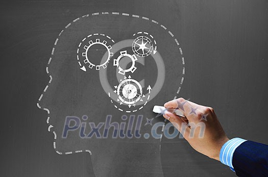 Businessman hand drawing with chalk gears mechanism as teamwork concept Businessman hand drawing with chalk gears mechanism as teamwork concept