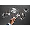 Businessman hand drawing with chalk gears mechanism as teamwork concept