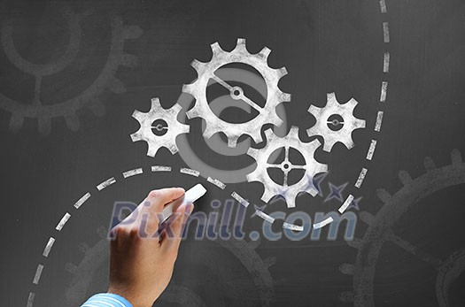 Businessman hand drawing with chalk gears mechanism as teamwork concept Businessman hand drawing with chalk gears mechanism as teamwork concept