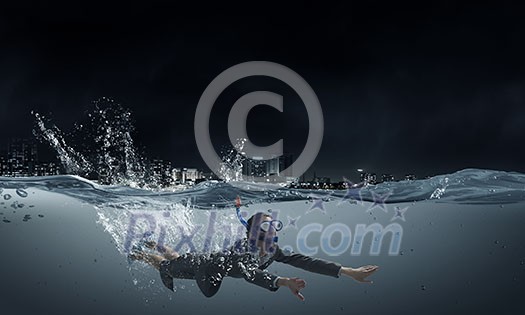 Young businesswoman in suit and diving mask swimming under water