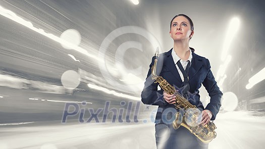Young woman in suit with saxophone in hands