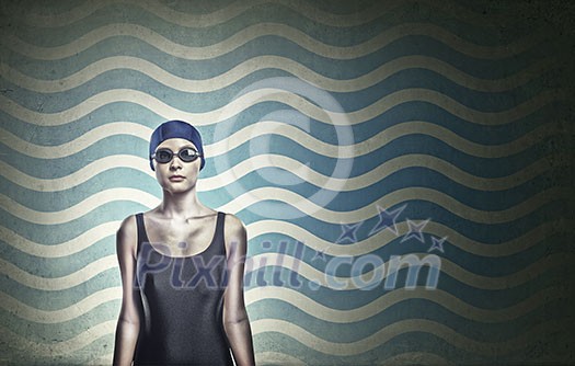 Portrait of woman swimmer in cap and glasses
