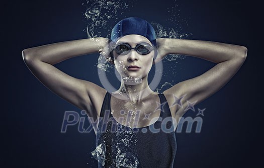 Portrait of woman swimmer in cap and glasses