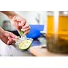 Young woman cooking in her modern kitchen (shallow DOF; color toned image)