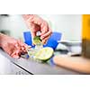 Young woman cooking in her modern kitchen (shallow DOF; color toned image)