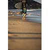 Young boy surfing the wave in a sunny day