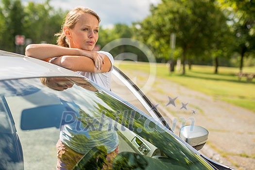 Young woman standing by her new car Young woman standing by her new car