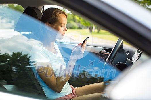 Young woman driving her car, on her way home from work - doing the daily commute Young woman driving her car, on her way home from work - doing the daily commute