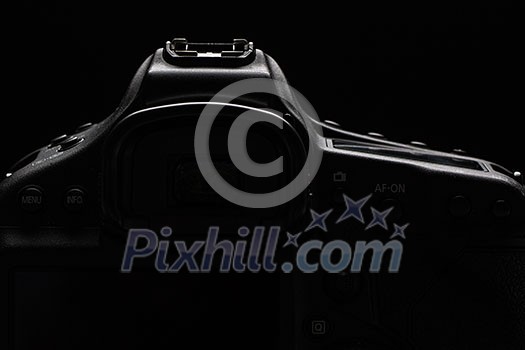 Professional modern DSLR camera low key stock photo/image - Modern DSLR camera with a very wide aperture lens on with highlighted edges against black background Professional modern DSLR camera low key stock photo/image - Modern DSLR camera with a very wide aperture lens on with highlighted edges against black background