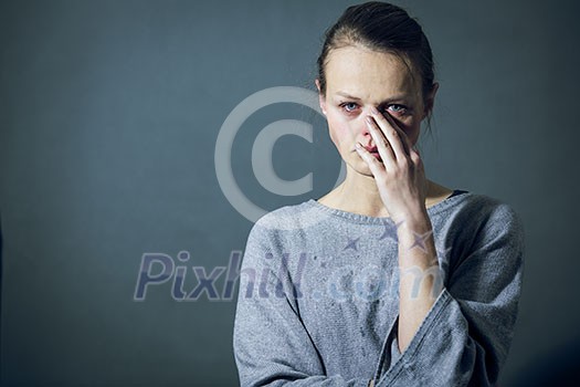 Young woman suffering from severe depression/anxiety/sadness, crying, tears coming from her eyes