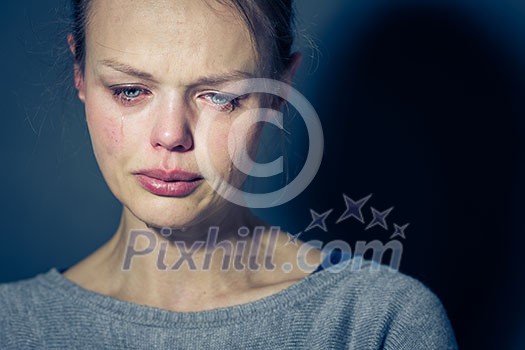 Young woman suffering from severe depression/anxiety/sadness, crying, tears coming from her eyes
