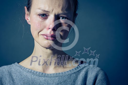 Young woman suffering from severe depression/anxiety/sadness, crying, tears coming from her eyes