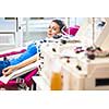 Pretty, young woman giving blood/plasma. Laying down while the procedure takes place (color toned image; shallow DOF)