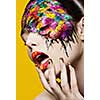 Beautiful fashion woman color face-art on yellow background