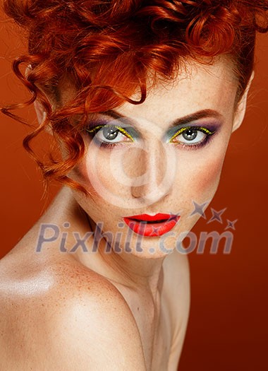 Red-haired. Beautiful girl with bright makeup. Ginger with freckles. 