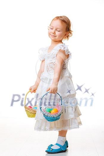 Little girl with baskets filled with Easter eggs