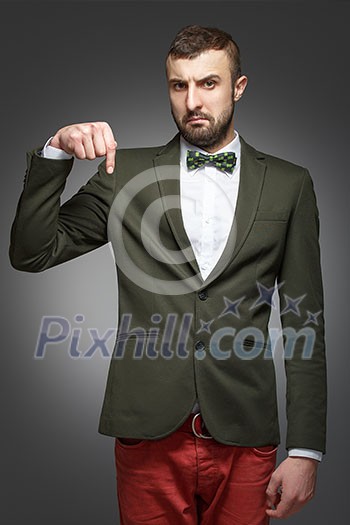 young man in a green suit, pointing down young man in a green suit, pointing down