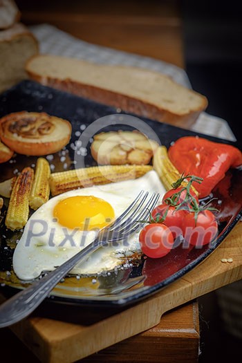 Fried egg on a plate with grilled vegetables