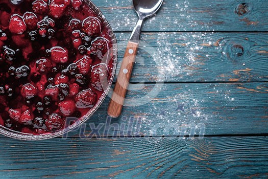 Berry pie on a wooden table. Copyspace for text on the right.
