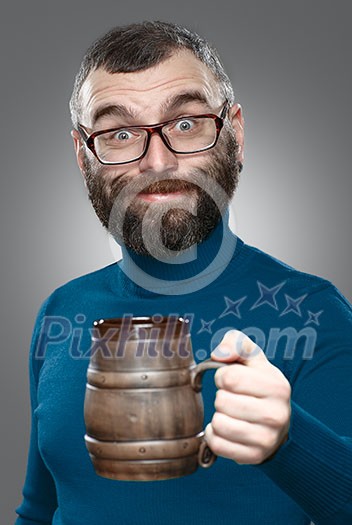 Happy man drinking beer from the mug.