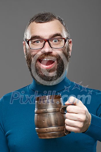 Happy man drinking beer from the mug.