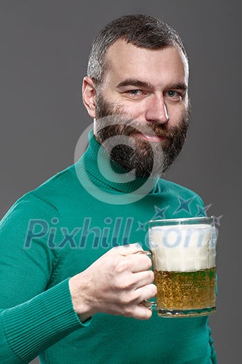 Happy man drinking beer from the mug.