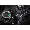 Professional modern DSLR camera - detail of the top LCD with settings - shutter speer, aperture, ISO, AF mode, battery info, RAW format indication,...
