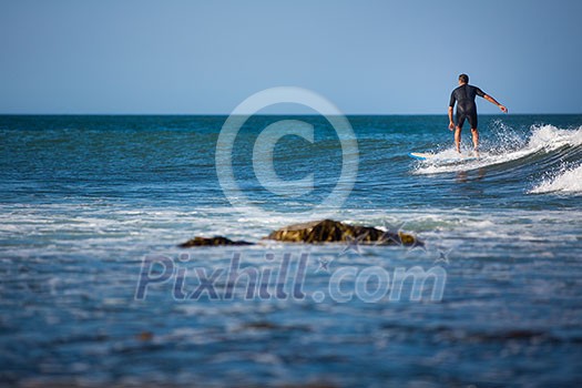 Young boy surfing the wave in a sunny day Young boy surfing the wave in a sunny day