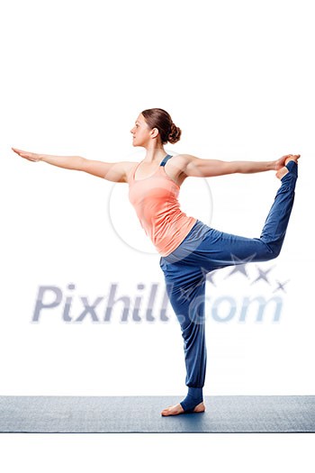 Beautiful sporty fit woman doing yoga asana Natarajasana - Lord of the dance pose isolated on white Beautiful sporty fit woman doing yoga asana Natarajasana - Lord of the dance pose isolated on white