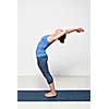 Beautiful sporty fit woman practices Sivananmda yoga asana Anuvittasana  - standing back bend pose