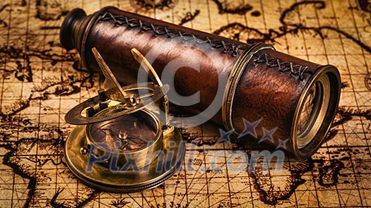 Travel geography navigation concept background - panorama of old vintage retro compass with sundial and spyglass on ancient world map